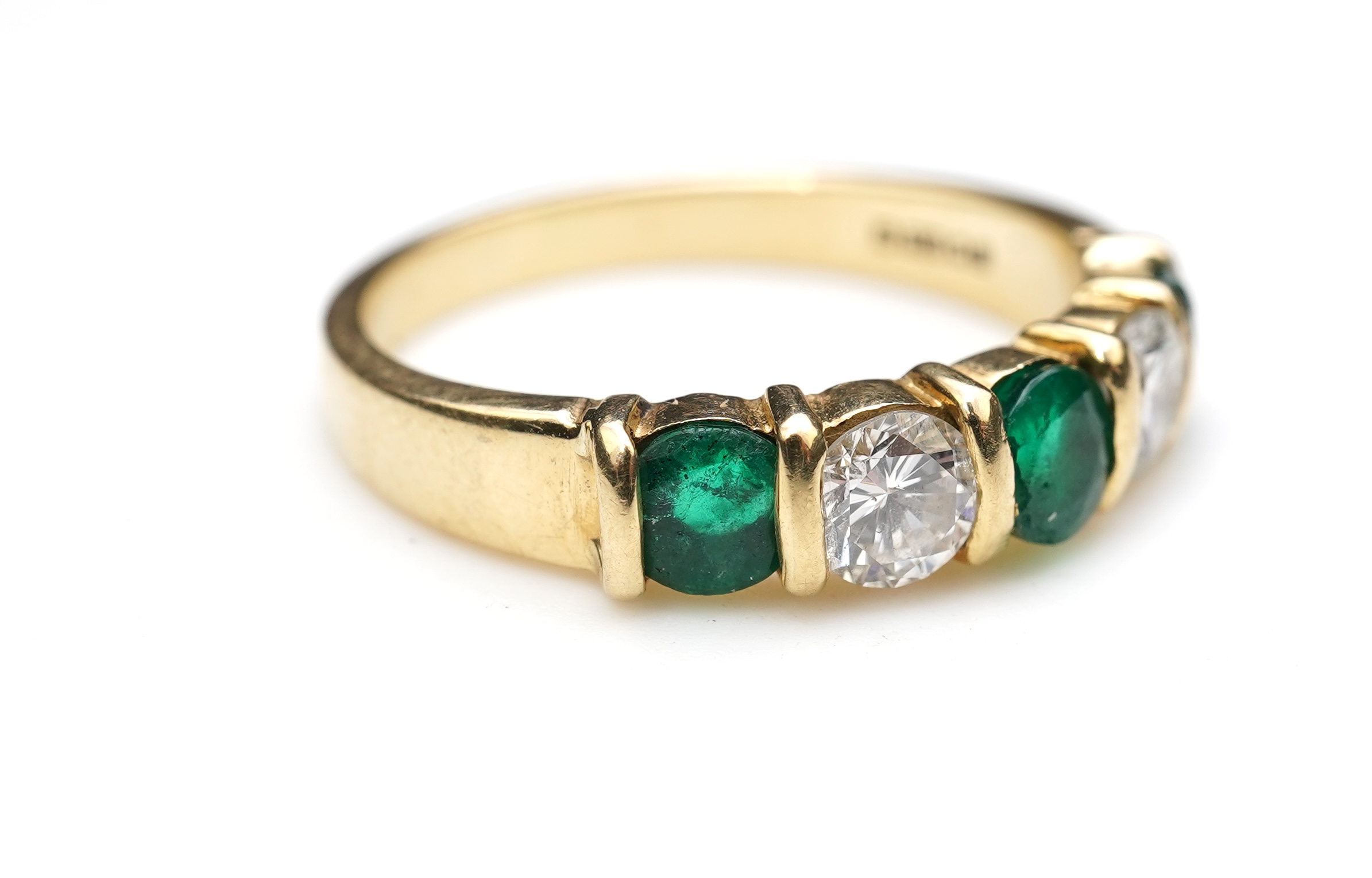 An emerald and diamond five-stone ring